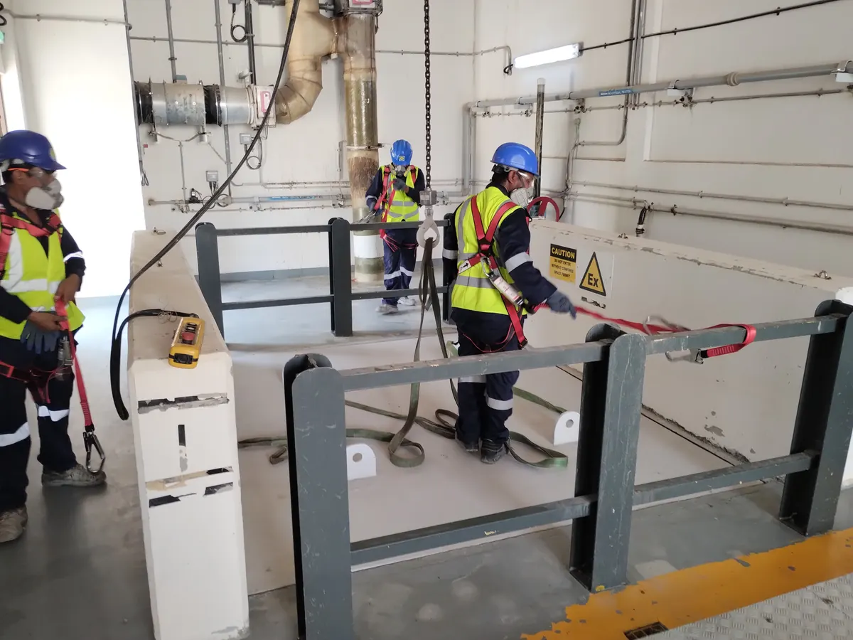 ESA technicians in PPE installing GRP panels in an industrial plant room