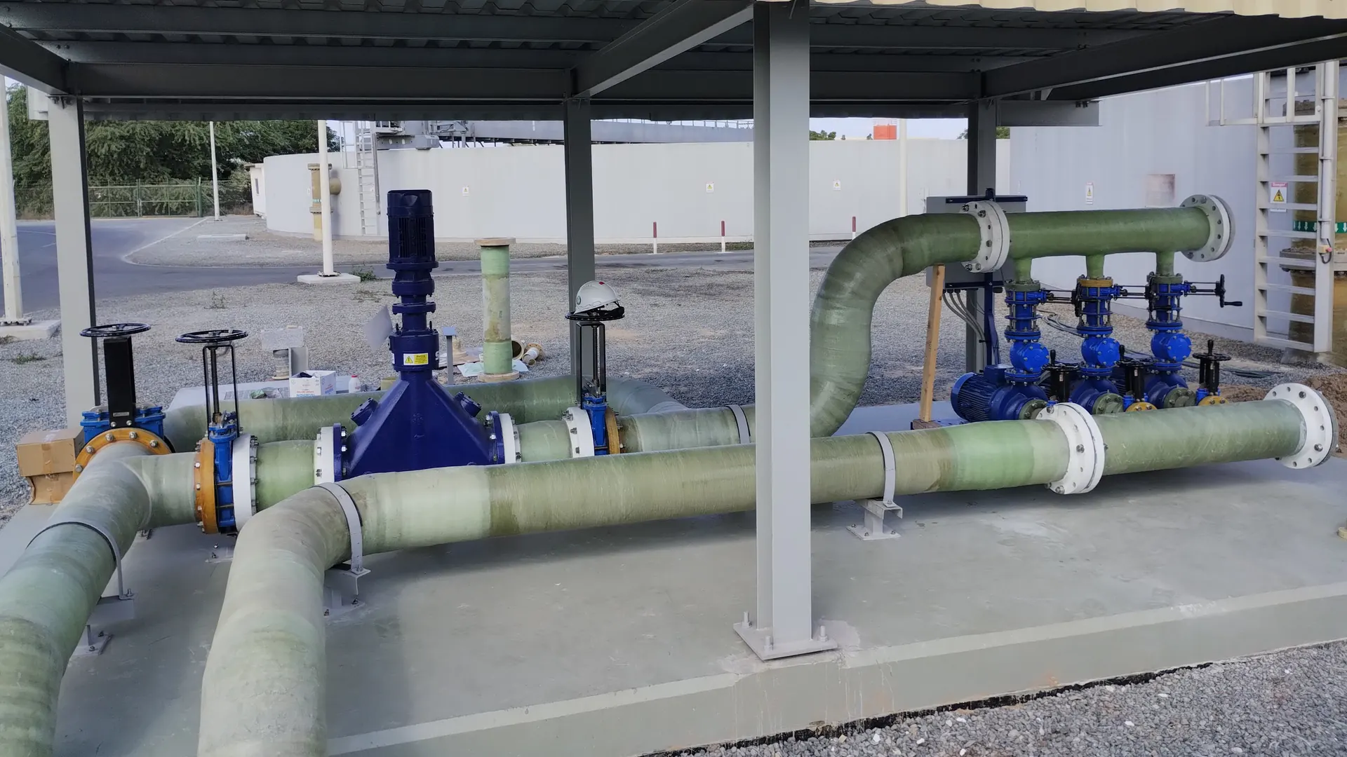 GRP pipework with flanged valves installed under a shade structure by ESA Technical Services in the UAE