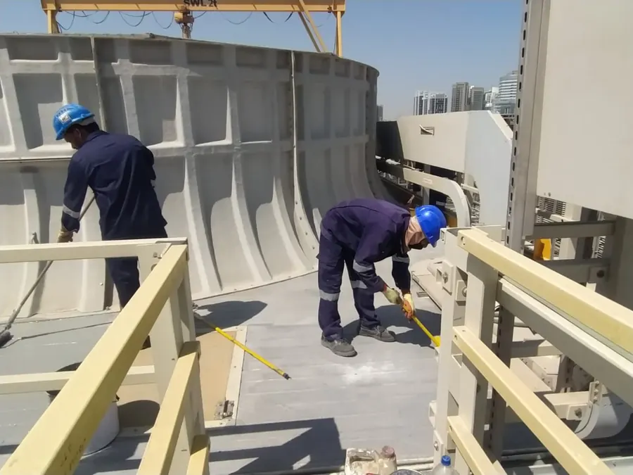 Technicians working on a large GRP basin structure