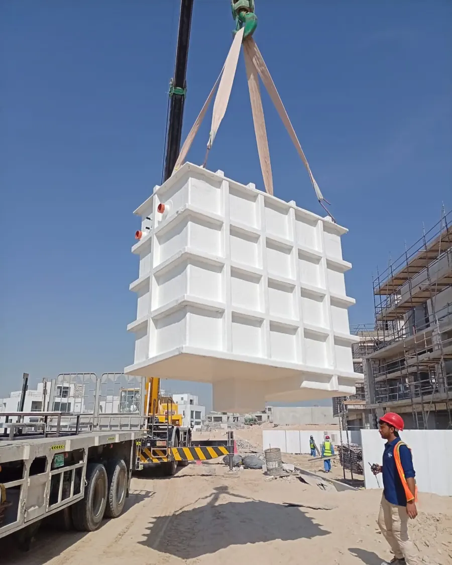 Prefabricated GRP tank being lifted into position by crane