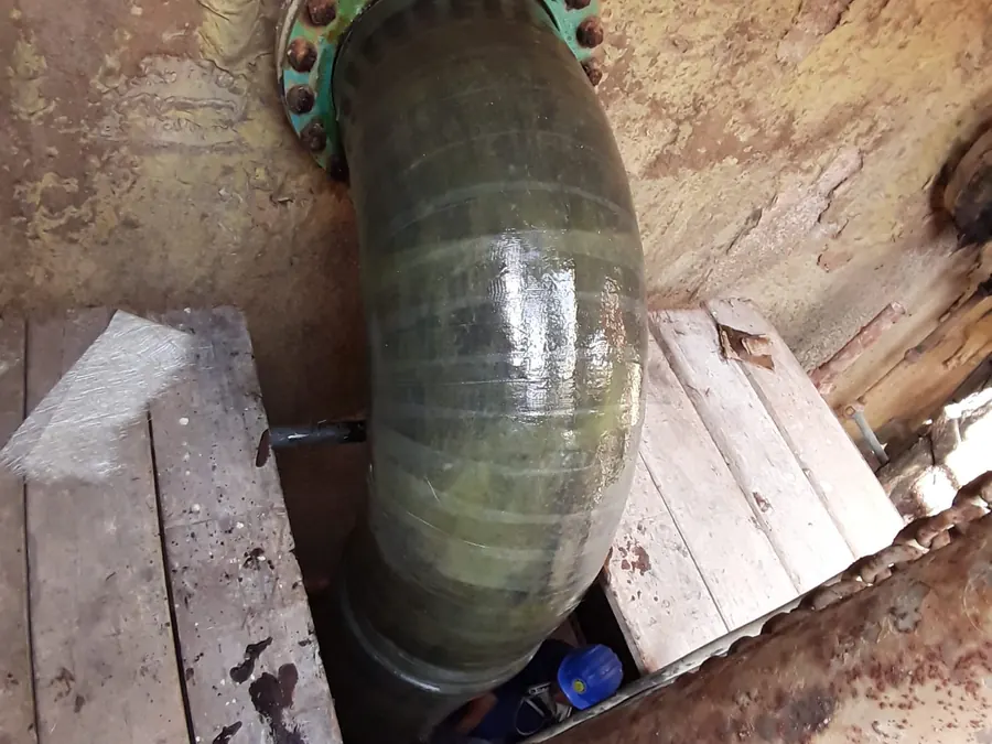 Laminated GRP bend with flange in a pit