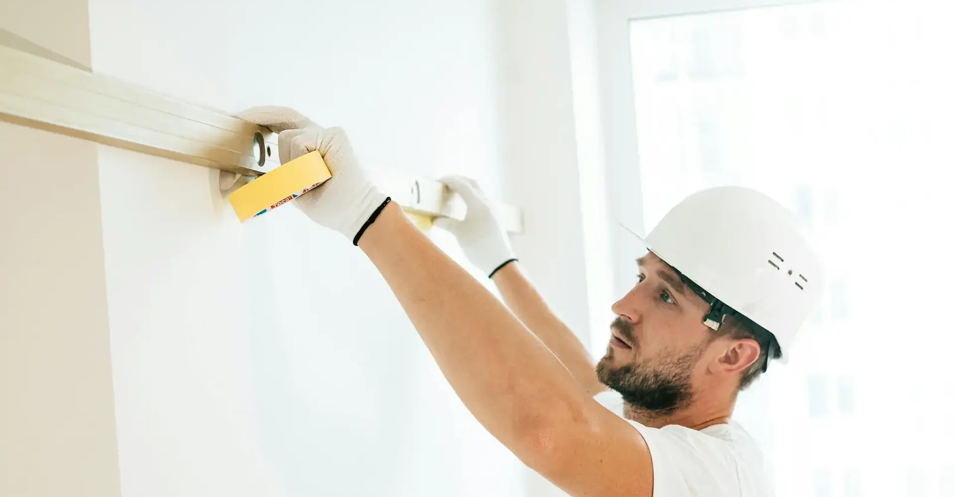 Technician using a spirit level during fit-out