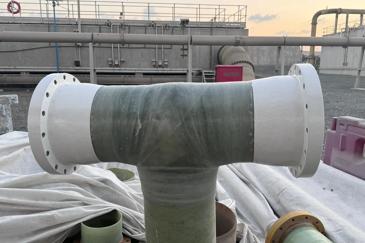 GRP tee fitting with laminated joints